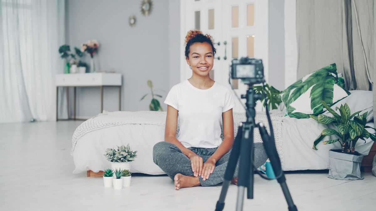 A lifestyle creator recording a video at home.